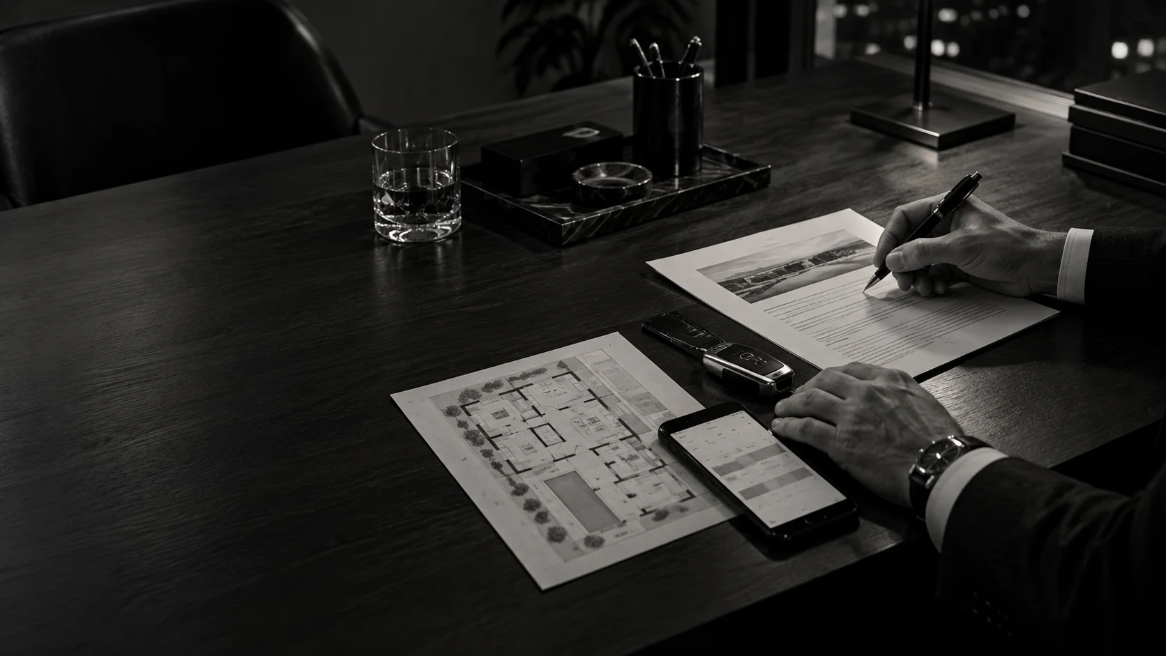A private operator reviewing a concise brief beside a property plan, phone, and vehicle key.